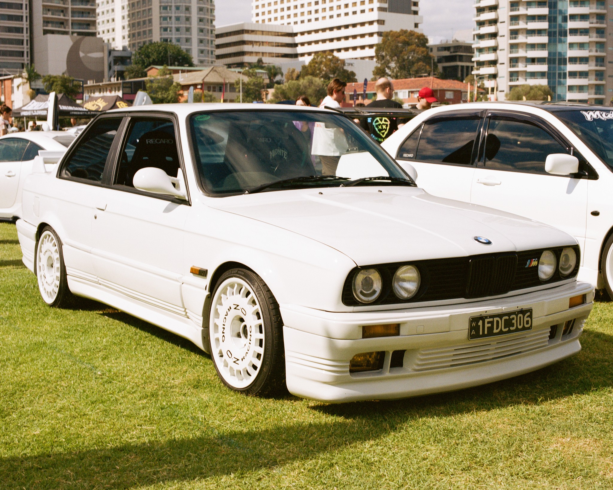 Three-quarter view of a white BMW E30 M3.