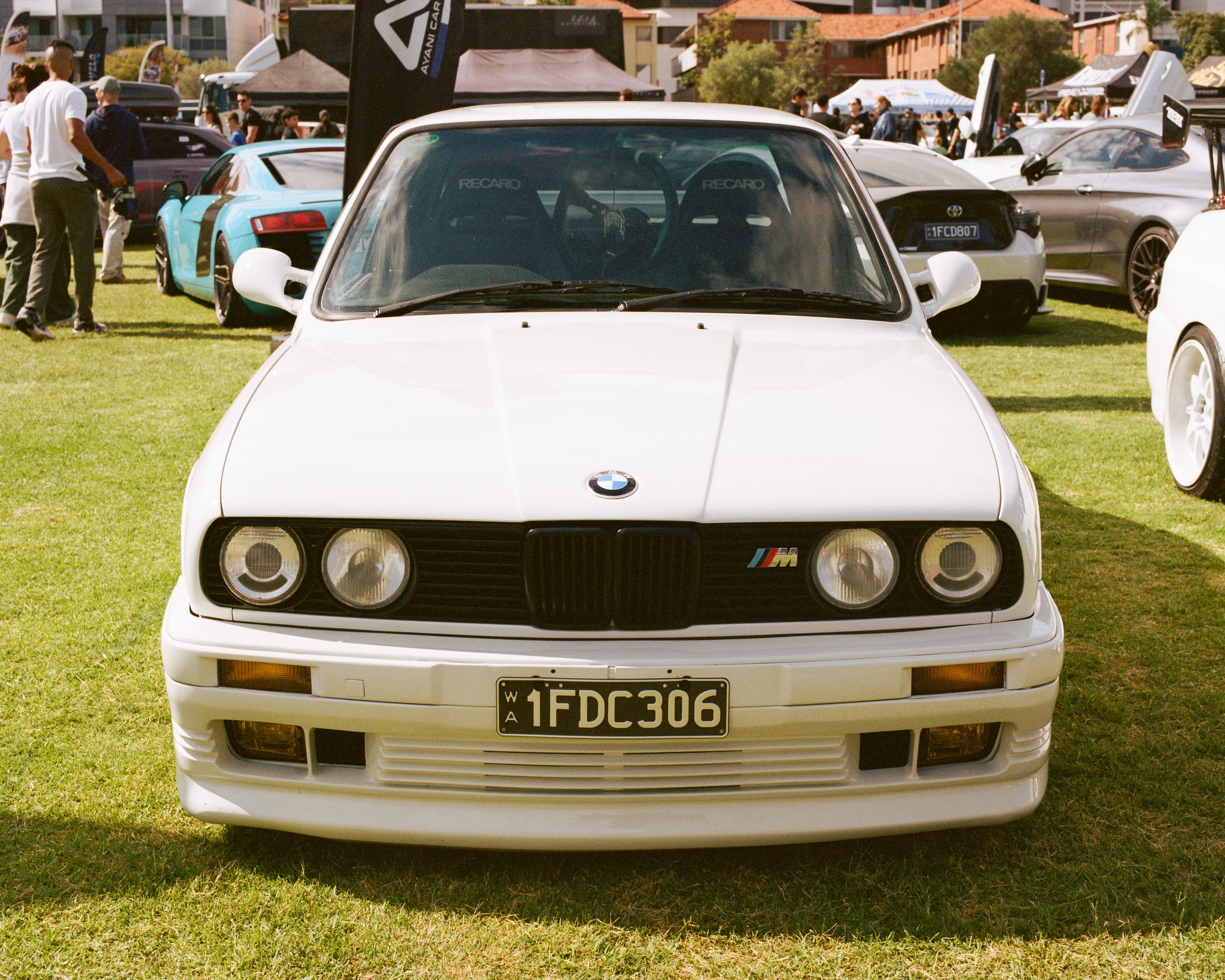 Head-on view of a white BMW E30 M3.