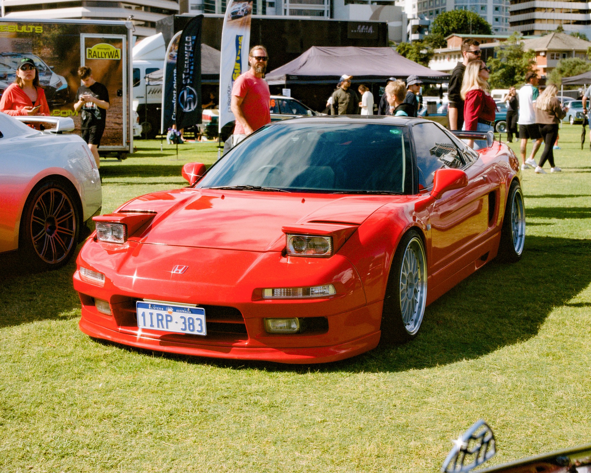 Red Honda NSX in three-quarter view.